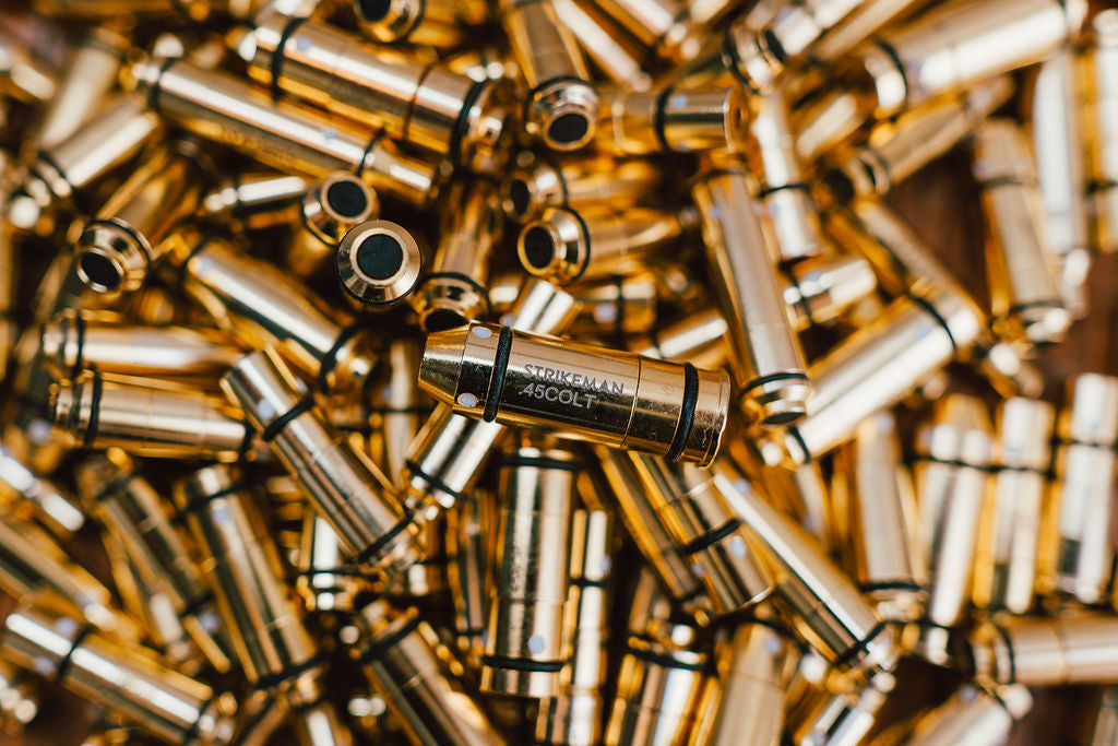 Strikeman laser cartridge among brass casings